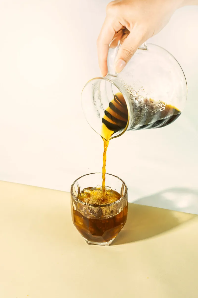 Espresso poured over tonic and ice in a clear glass